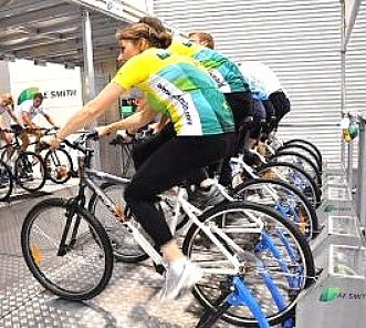 Office workers working out on the stationary bikes